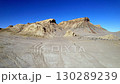 Rocky cliffs and canyon formations of the Mangystau desert under a bright blue sky 130289239