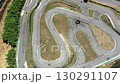 Aerial drone shot of go karts racing on winding 130291107