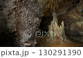 A speleologist explores a cave, illuminated by a headlamp 130291390