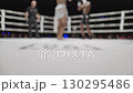 Low angle view of kickboxers fighting in a ring 130295486