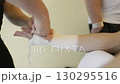 Coach wrapping boxer's hands with bandages 130295516