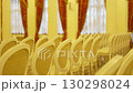 Bright hall filled with neatly arranged rows of chairs 130298024