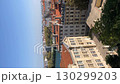 View of red-roofed buildings and river with distant cityscape under clear blue sky video 130299203