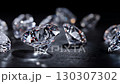 Sparkling diamonds scattered on a dark surface showcasing brilliance and elegance in luxury 130307302