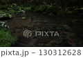A waterfall leading to the Kikuchi Gorge with a clear stream flowing through nature 130312628