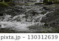 A waterfall leading to the Kikuchi Gorge with a clear stream flowing through nature 130312639