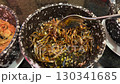 Dry salty fish anchovies on a plate close-up macro. Dried fish snack for beer party at the cafe or bar. Salt and fry snacks food  130341685