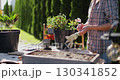 Preparation for transplanting a houseplant using extended clay, soil, shovel, rake and flowerpot. Home gardening. Hobbies and leisure concept. 130341852