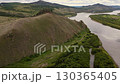 Scenic view of river winding through lush hills in remote landscape 130365405