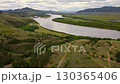 Scenic river valley view with rolling hills and lush greenery in Montana 130365406