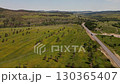Stunning aerial view of rolling green hills and winding road in Wyoming 130365407