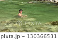 Teen Boy Swimming in Clear River with Flowing Water 130366531