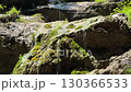 Cascading Water Over Mossy Rocks in Nature 130366533