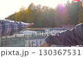 Construction workers discussing project details at building site. Workers using hand gestures near partially constructed concrete block and reinforced concrete structures. Close up arms of builders 130367531