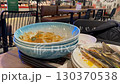 Dirty dishes stacked at a restaurant table after a meal, suggesting dining experience video 130370538