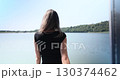 A Womans Journey Awakening to the Beauty of Nature by the Calm and Inviting Water 130374462
