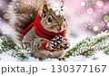 Cute squirrel wears vibrant red scarf while gripping pine cone. Surrounding landscape features fresh snow and gentle snowfall, creating peaceful winter ambiance 130377167