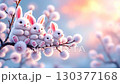 Fluffy rabbits gather on a branch while soft blossoms bloom around them. A colorful sunset creates a calming backdrop, enhancing this delightful nature moment 130377168
