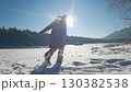 Joyful winter day outdoors: female enjoying snowy landscape and sunshine 130382538