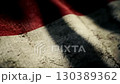 Textured Indonesian flag waving in slow motion conveying a sense of history	 130389362