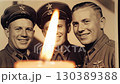 Nostalgic tribute featuring vintage Soviet military photo with a candle flame	 130389388