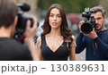 Reporter conducts interview on location as camera crew captures the moment in a busy urban setting 130389631