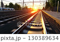 Sunset railway tracks with vibrant colors creating a picturesque view in an urban setting 130389634