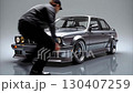 Drift retro car BMW. The driver gets into the car and backs out of the frame with wheelspin. 130407259