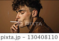 A video of a young man smoking. A studio video of a male model smoking a cigarette. 130408110