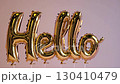 Gold balloon letters spelling hello on pink background, festive decoration concept 130410479