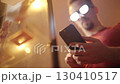 Man with anime glowing glasses swiping on smartphone 4K 130410517