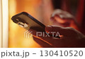 Person hand swiping on smartphone close-up 4K 130410520