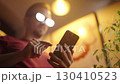 Man with anime glowing glasses swiping on smartphone 4K 130410523