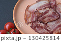 Cooked fried crispy bacon as an ingredient of a delicious English breakfast. Pieces of fried bacon as a background for your design 130425814