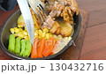 Delicious and juicy chicken steak with a creamy white sauce, sizzling on a hot plate with corn, carrots, and potatoes. Perfect for food blogs, restaurant menus, and cooking shows. 130432716
