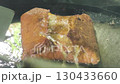 Crispy martabak telor, a traditional Indonesian fried food, being prepared with skill and care, showcasing authentic street food cooking. 130433660