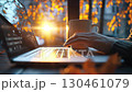 Golden sunlight warming freelancer typing on laptop, autumn leaves softly blurring, steaming coffee nearby, embodying peaceful remote work atmosphere 130461079