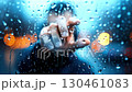 Rain, glass, figure pressing palm against rain covered glass, city lights blending through droplets during nocturnal cityscape moment, Rain, glass, figure 130461083