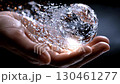 Glittering crystal sphere fragmenting, transforming into luminous sparkling particles against deep shadowy backdrop, representing magical metamorphosis 130461277