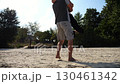 Carefree lovers having fun together on seashore at summer vacation. Man taking his beloved in air, turning around and kissing her at coastline. Happy couple spending time at sandy beach. Slow mo 130461342