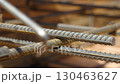 Strapping of reinforcing steel rods in foundation construction close up view 130463627