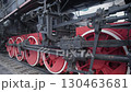 This clip showcases a vintage steam locomotive with striking red wheels, highlighting the intricate craftsmanship of early 20th-century rail technology at a historic railway site. 130463681