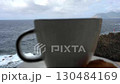 A morning cup of Italian coffee against the backdrop of the sea and rocks 130484169