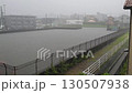The flood control basin is approaching full capacity when a heavy rain and flood warning is issued (wide-angle shot, surveillance camera footage) 130507938