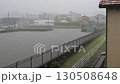 The flood control basin is approaching full capacity when a heavy rain and flood warning is issued (wide-angle shot, surveillance camera footage) 130508648
