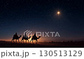 Journey of the Magi. Mystical silhouettes of the Three Wise Men riding camels across the desert under a starry night, following the Christmas Star a timeless symbol of Christmas stories and sacred 130513129