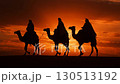 Journey of the Magi. Mystical silhouettes of the Three Wise Men riding camels across the desert under a starry night, following the Christmas Star a timeless symbol of Christmas stories and sacred 130513192