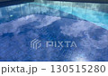 Modern infinity swimming pool with clear water reflecting cloudy blue sky and glass wall, creating luxury and tranquil atmosphere, ideal for resort, hotel, vacation, real estate, and wellness concept 130515280