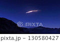 Bright meteor flying over mountain range at twilight 130580427