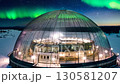 Northern lights illuminating arktikum museum in rovaniemi, finland 130581207